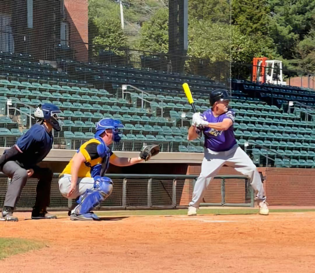 Coach Navarre catching at the Tusculum University stadium